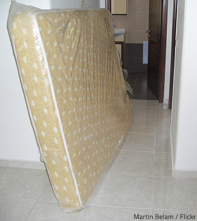 Moving a mattress in the rain is a great challenge.